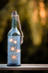 bottle with star lights inside, glowing fuzzy background