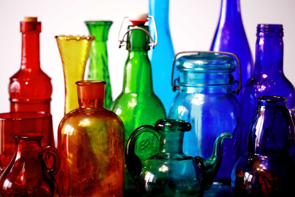 glass bottles of various sizes and shapes, rainbow of colors