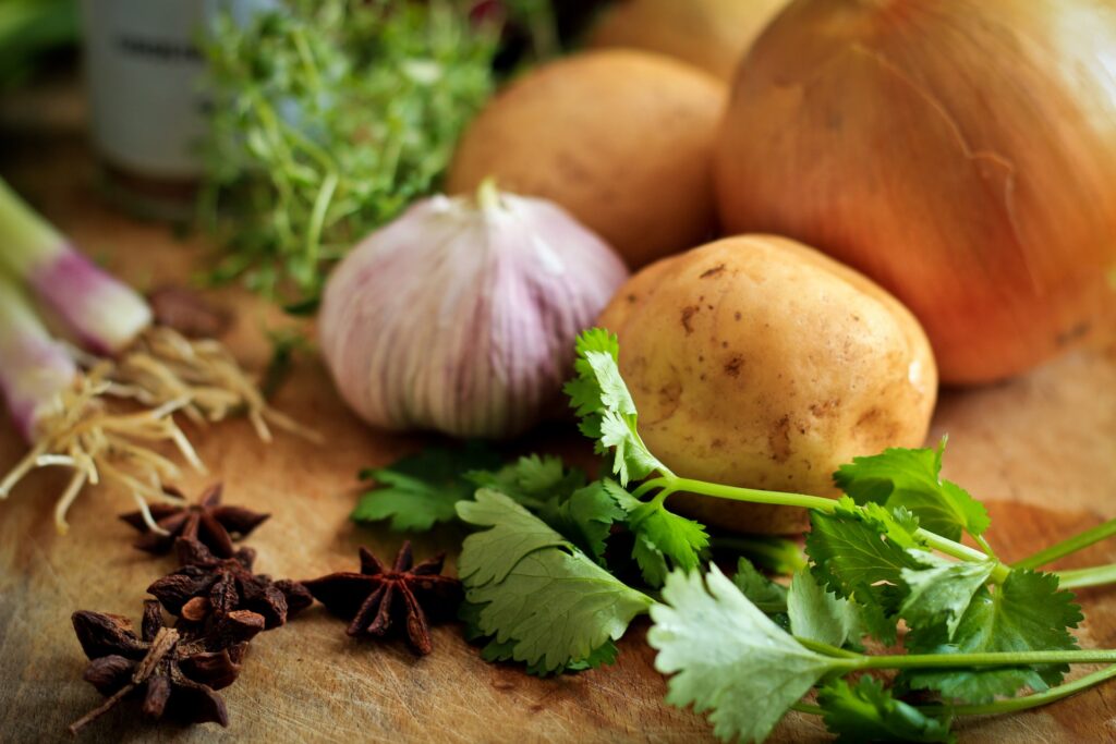 cilantro garlic star anise onion on cutting board