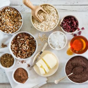 bowls for recipe prep with oats, nuts, berries, butter and chocolate