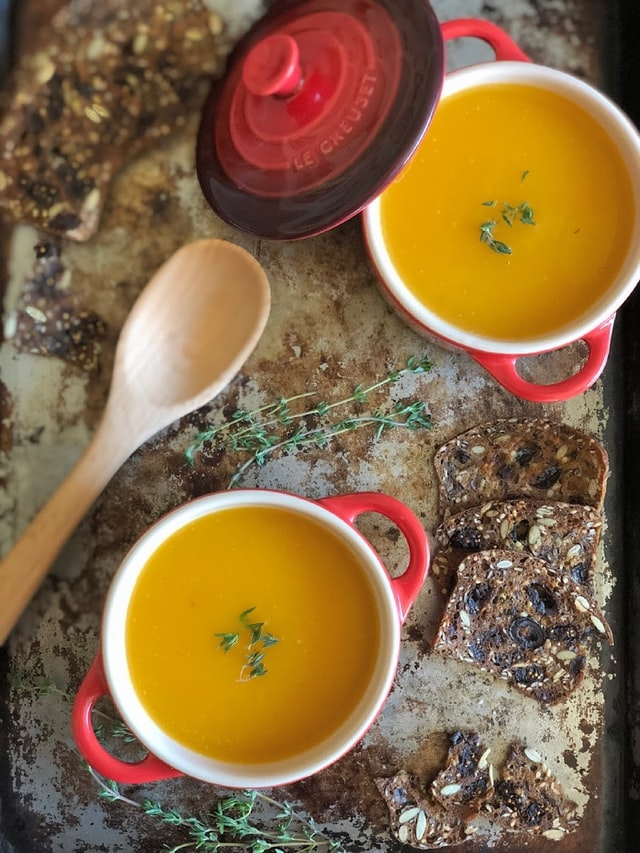 pumpkin soup in red crocks
